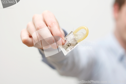 Image of Man holding condom