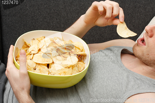 Image of Man eating chips