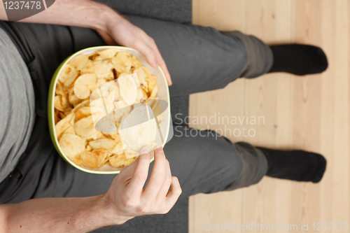 Image of Man eating chips