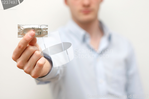 Image of Man holding condom
