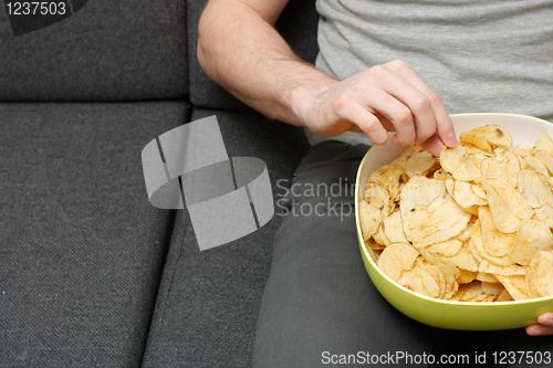 Image of Man eating chips