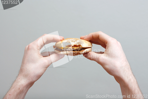 Image of Man eating burger