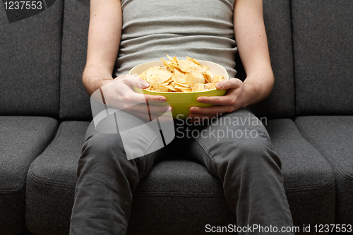 Image of Man eating chips