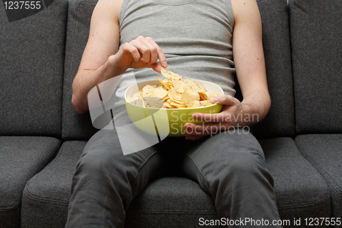 Image of Man eating chips