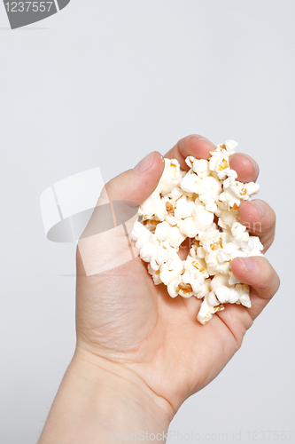 Image of Hand holding popcorn