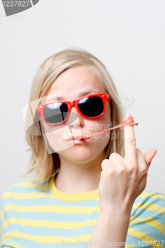Image of Girl playing with gum