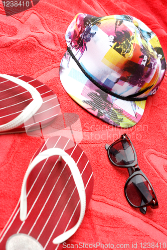 Image of Flip flops, sunglasses and a cap