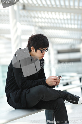 Image of man texting on cell phone