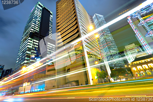 Image of light trails on the modern building background in Hong Kong