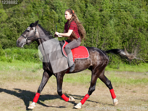 Image of A girl riding a horse