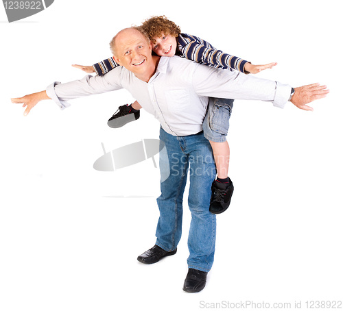 Image of Grandfather giving grandson piggy-back