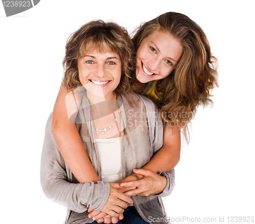 Image of Pretty daughter hugging her mom from back