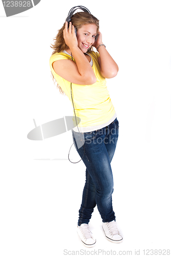 Image of Cheerful caucasian woman listening and enjoying music