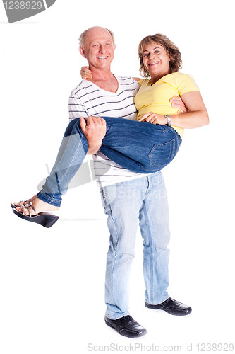 Image of Playful senior couple having fun indoors