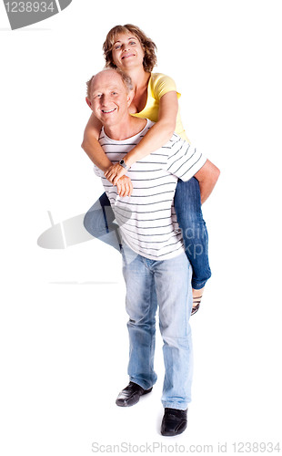 Image of Senior man giving woman piggyback ride