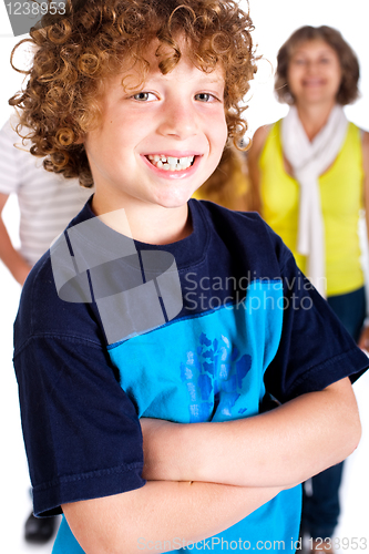 Image of Young cute boy in focus with family in the background