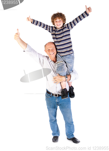 Image of Grandfather giving grandson piggy-back