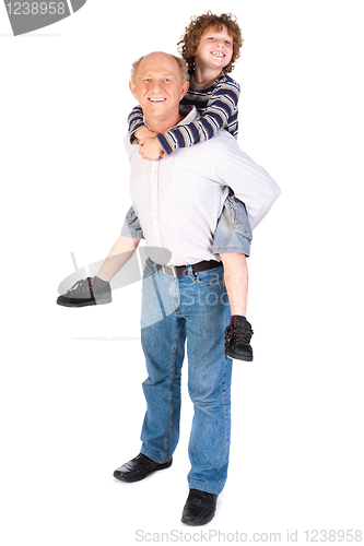 Image of Grandfather giving grandson piggy-back