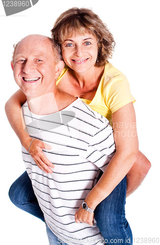 Image of Senior man giving woman piggyback ride