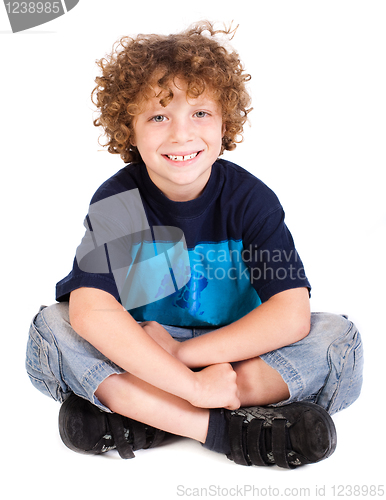 Image of Cheerful kid relaxing on floor