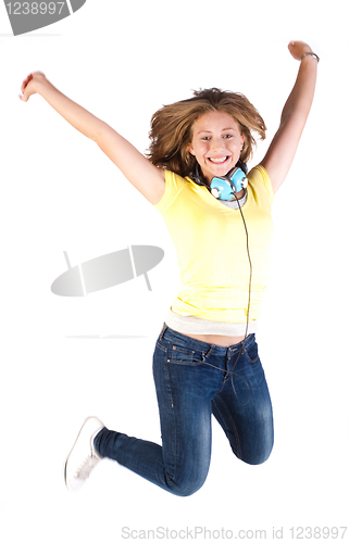Image of Girl jumping high with headphones around her neck