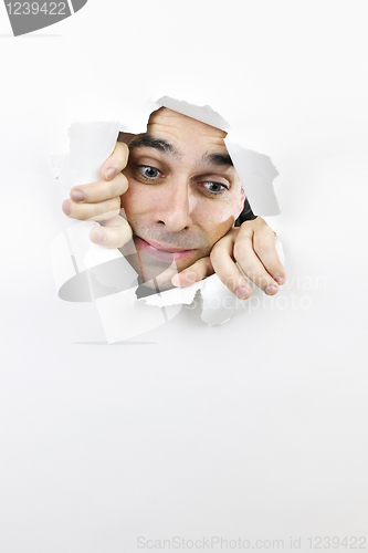 Image of Face looking through hole in paper