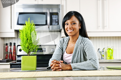 Image of Young woman in kitchen