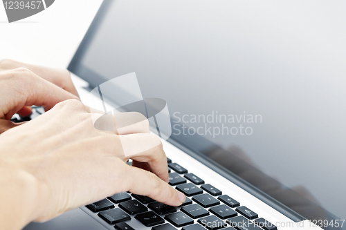 Image of Hands typing on laptop keyboard