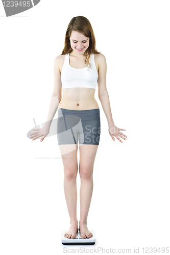 Image of Fit young girl checking her weight