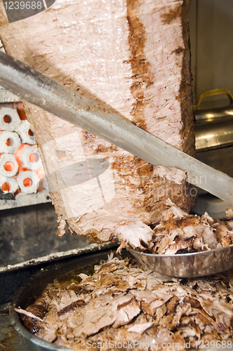 Image of skewered meat roasted cut with knife for gyro shishkebab Istanbu