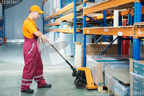 Image of worker with fork pallet truck