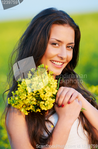 Image of girl with flowers at summer field