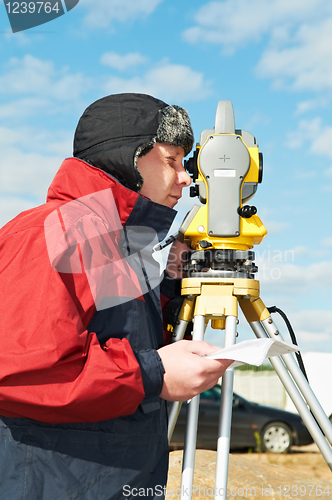 Image of surveyor works with theodolite tacheometer