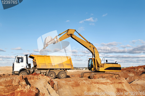 Image of track-type loader excavator and tipper dumper