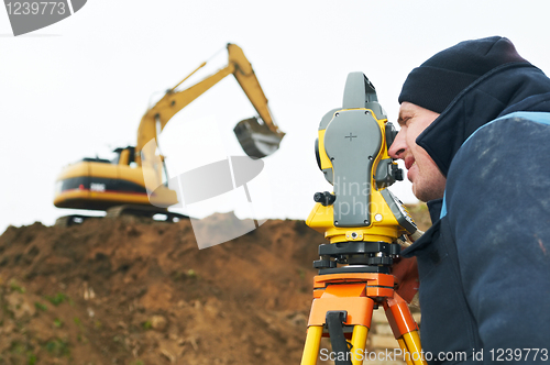 Image of surveyor works with theodolite tacheometer