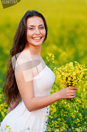 Image of girl with flowers at summer field