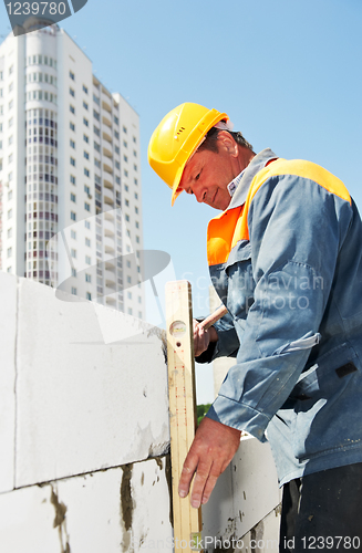 Image of bricklayer at construction masonry works