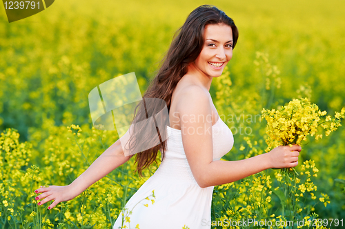 Image of girl with flowers at summer field