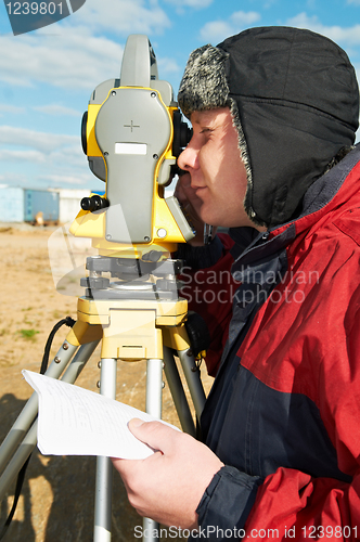 Image of surveyor works with theodolite tacheometer