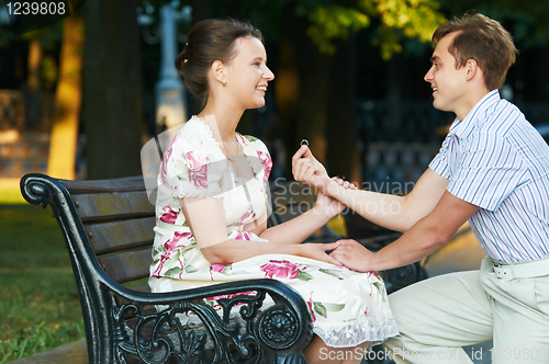 Image of offer of marriage outdoors