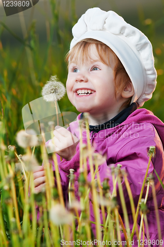 Image of baby with dandelion