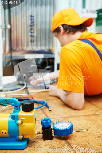 Image of repair work on fridge appliance