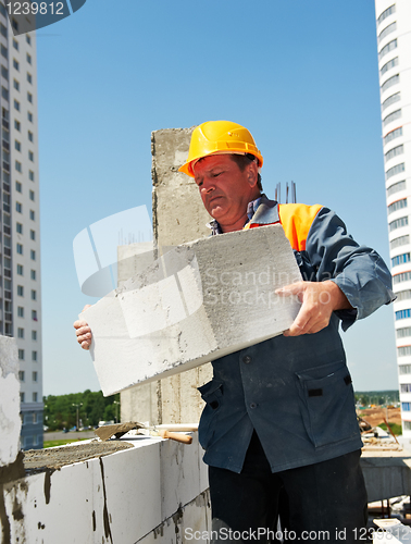 Image of bricklayer at construction masonry works