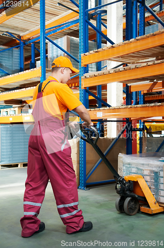 Image of worker with fork pallet truck