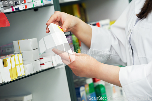 Image of closeup hand of chemist with drug