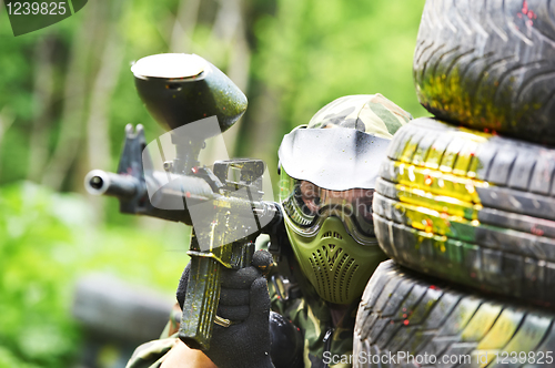 Image of paintball player holding position