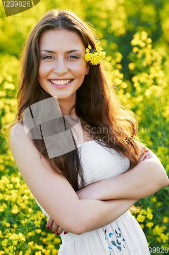 Image of girl with flowers at summer field