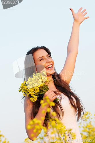 Image of girl with flowers at summer field