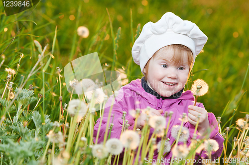 Image of baby with dandelion