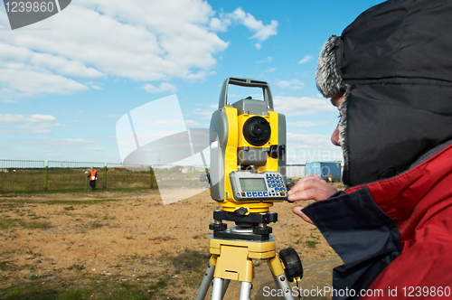 Image of surveyor works with theodolite tacheometer